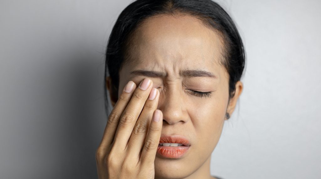 Woman rubbing her eye