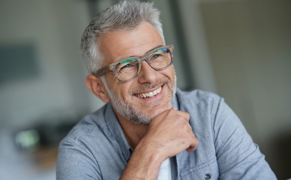 Smiling older man wearing glasses.