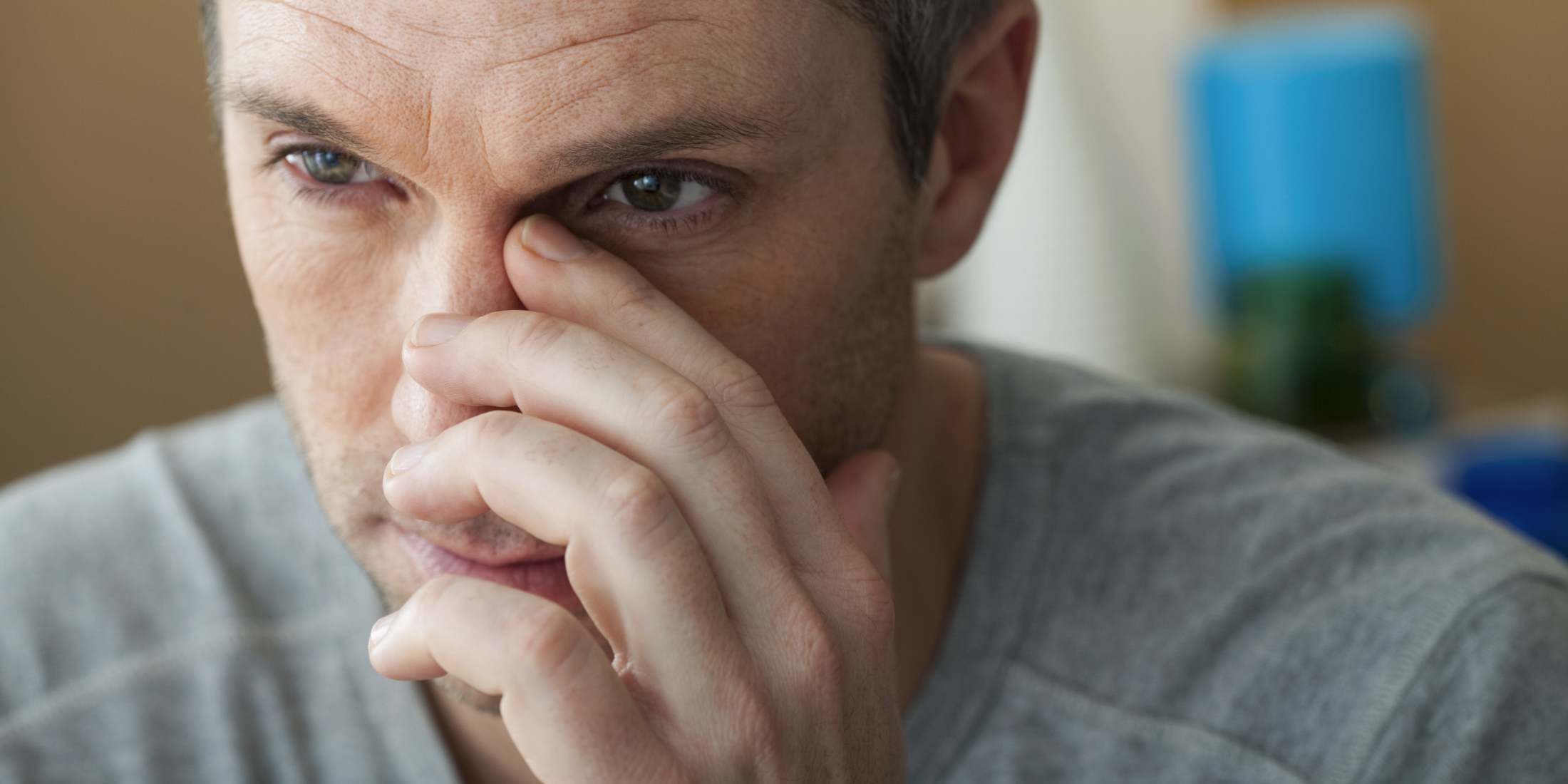 Man touching his nose and face